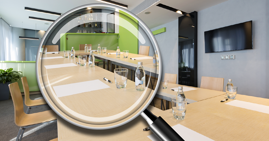 magnifying glass over meeting room